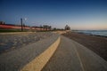 Granolite and paving stones covered front sea promenade with train passing behind Royalty Free Stock Photo
