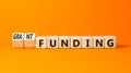 Grant funding symbol. Concept words Grant funding on beautiful wooden blocks. Beautiful orange table orange background. Business Royalty Free Stock Photo