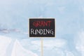 Grant funding symbol. Concept words Grant funding on beautiful yellow black blackboard. Beautiful blue ice background. Business Royalty Free Stock Photo