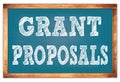 GRANT PROPOSALS words on blue wooden frame school blackboard