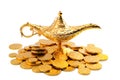 Grant a wish, desiring financial wealth with a old golden magic lamp on gold coins isolated on white background with clipping path Royalty Free Stock Photo