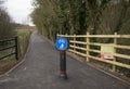 Grantham Canal new entrance asphalt floor and round blue sign for pedestrians and cyclists