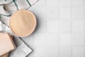 Granulated and compressed yeast in bowl on white tiled table, flat lay. Space for text