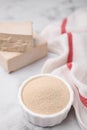 Granulated and compressed yeast on white marble table, closeup