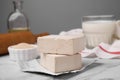 Granulated and compressed yeast on white marble table, closeup