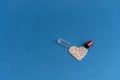 Granules poured from a heart-shaped capsule on a classic blue background. Heart shaped medicines. Heart symbol drawn by Royalty Free Stock Photo