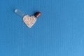 Granules poured from a heart-shaped capsule on a classic blue background. Heart shaped medicines. Heart symbol drawn by Royalty Free Stock Photo