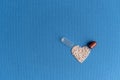 Granules poured from a heart-shaped capsule on a classic blue background. Heart shaped medicines. Heart symbol drawn by Royalty Free Stock Photo