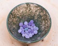 Grape Agate Balls from Indonesia in Moss Agate hand carved polished bowl from Morocco.