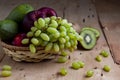 Grape fruit with kiwi fruit on a wooden table. Royalty Free Stock Photo