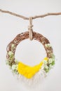 Grape ring cradle for newborns on a white background, decorated with green flowers eustomas with a yellow rug