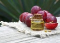 Grape seed oil in a glass jar and fresh grapes on old wooden table.Bottle of organic grape seed oil for spa and bodycare. Royalty Free Stock Photo