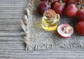 Grape seed oil in a glass jar and fresh grapes on old wooden table.Bottle of organic grape seed oil for spa and bodycare. Royalty Free Stock Photo