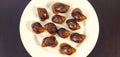 Grape snails, akhatina, on a plate, as crude food, a rawism Royalty Free Stock Photo