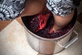 Grape-treading for wine, traditional for home winemaking. Stomping grapes with bare feet. Royalty Free Stock Photo