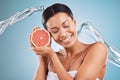 Grapefruit, black woman and water for skincare, cosmetics and hygiene with blue studio background. Citrus, young female