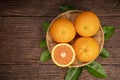 Fresh Oranges with Oranges slices on wooden Background, Grapefruit or Cara Cara orange with leaves in Wooden background.