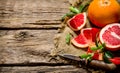 He grapefruit cut on the old fabric with leaves and knife. Royalty Free Stock Photo