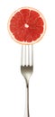 Grapefruit cut piece on impaled on a fork isolated on white background with clipping path Royalty Free Stock Photo