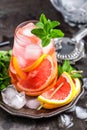 Grapefruit and fresh mint cocktail with juice, cold summer citrus refreshing drink or beverage with ice Royalty Free Stock Photo