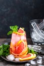 Grapefruit and fresh mint cocktail with juice, cold summer citrus refreshing drink or beverage with ice Royalty Free Stock Photo