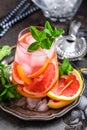 Grapefruit and fresh mint cocktail with juice, cold summer citrus refreshing drink or beverage with ice Royalty Free Stock Photo