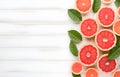 grapefruit fruit slice heart shape and leaves on white wooden table top view