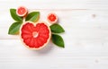 grapefruit fruit slice heart shape and leaves on white wooden table top view