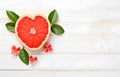 grapefruit fruit slice heart shape and leaves on white wooden table top view