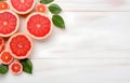 grapefruit fruit slice heart shape and leaves on white wooden table top view