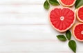 grapefruit fruit slice heart shape and leaves on white wooden table top view