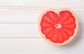 grapefruit fruit slice heart shape on white wooden table top view