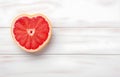 grapefruit fruit slice heart shape on white wooden table top view