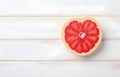 grapefruit fruit slice heart shape on white wooden table top view