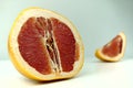 Grapefruit with grapefruit slice isolated on white background close up. Royalty Free Stock Photo