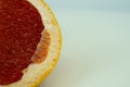 Grapefruit with grapefruit slice isolated on white background close up. Royalty Free Stock Photo