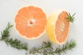 Grapefruit Halves and Rosemary Sprigs Royalty Free Stock Photo