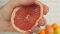 Grapefruit Image with Hand Pressing Half of Fruit and Squeeze the Juice Royalty Free Stock Photo
