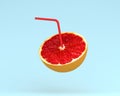 Grapefruit juice, Orange slice with Straw on pastel blue background. minimal idea food and fruit concept. Idea creative to Royalty Free Stock Photo