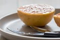 Grapefruit knife and spoon in front of grilled grapefruit focus on knife Royalty Free Stock Photo