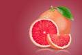 Grapefruit with leaf on red background. With clipping path. Full depth of field.