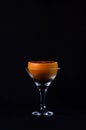 Grapefruit in a martini glass on a black background