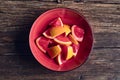 Grapefruit pieces in a red bowl