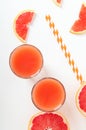 Grapefruit refreshing juice with straws on a white background with grapefruit slices. Summer refreshing diet drink Royalty Free Stock Photo