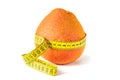 Fresh grapefruit wrapped with measuring tape. The concept of healthy nutrition, weight loss, dietetics