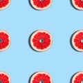 Grapefruit seamless pattern on a blue background. Tropical abstract background. Top view, flat lay