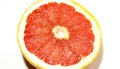Grapefruit in section closeup, on a white background Royalty Free Stock Photo