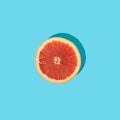 Grapefruit slice on blue background. Minimal summer fruits concept. Pop art Royalty Free Stock Photo