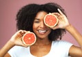 Grapefruit, smile and face portrait of black woman in studio isolated on a pink background. Natural, fruit and African