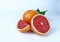 Grapefruit whole, cut in half and a quarter on a white background close-up.